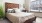a bedroom with a bed and a side table