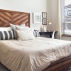 a bedroom with a bed and a side table