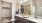 a bathroom with twin sinks and toilet and a closet