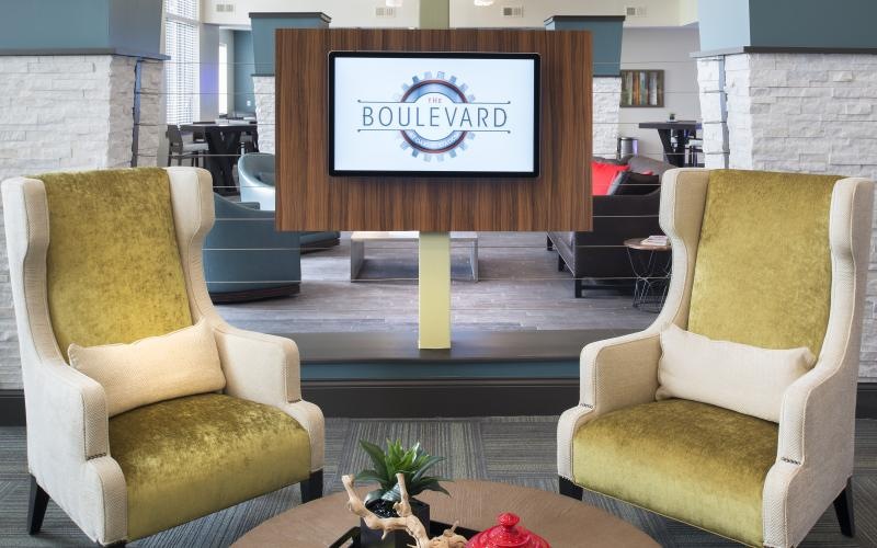 a lobby area with a tv and chairs